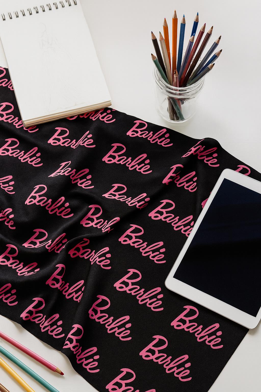 Barbie Fabric: Pink Logo Text, Black Linen-Look Polyester, 44" Wide