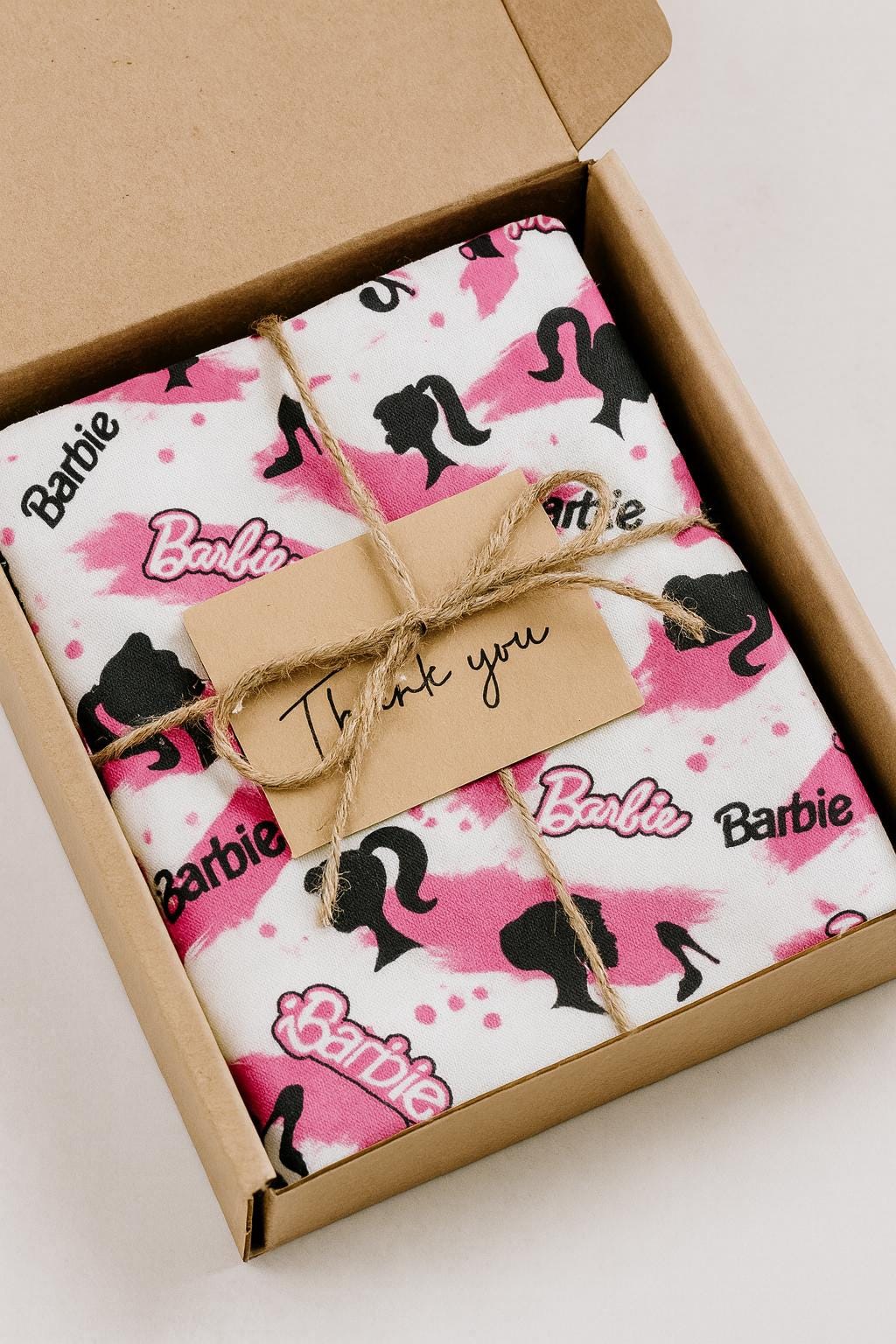 Barbie Fabric: Pink Logo Text, Black Linen-Look Polyester, 44" Wide